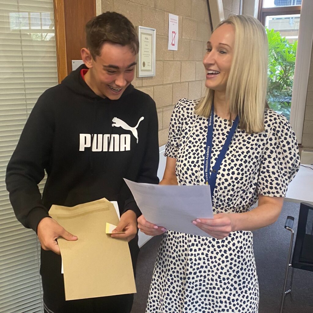 Student at Brooke Weston Academy in Corby finds out his GCSE results with teacher in 2024.